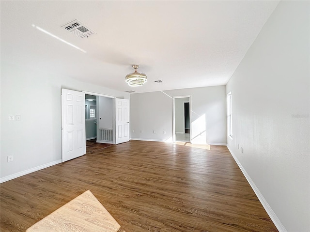 unfurnished room featuring dark hardwood / wood-style floors