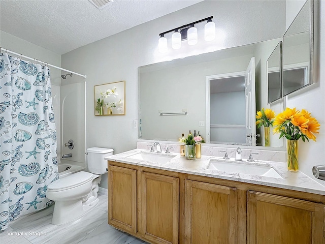 full bathroom featuring shower / bathtub combination with curtain, vanity, toilet, and a textured ceiling