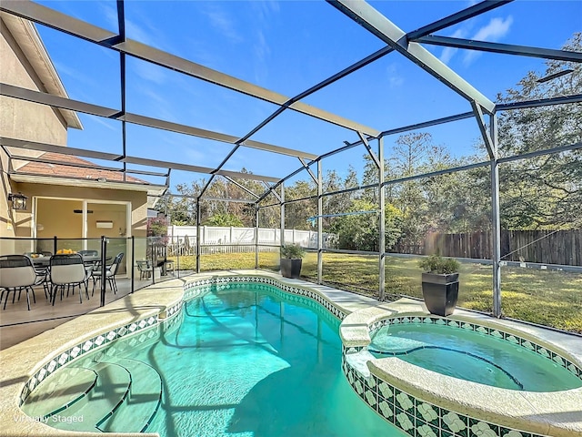 view of pool with an in ground hot tub, a yard, glass enclosure, and a patio area