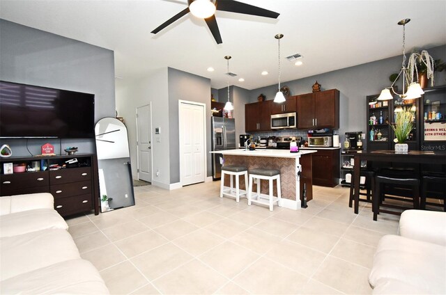 tiled living room with ceiling fan