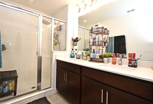 bathroom featuring vanity, an enclosed shower, and tile patterned floors