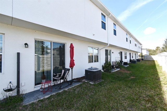 view of home's exterior with central AC and a lawn