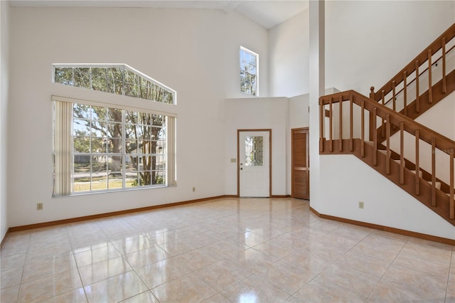 tiled foyer featuring a high ceiling