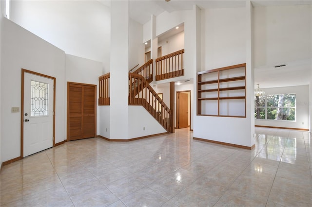 foyer with a towering ceiling and an inviting chandelier