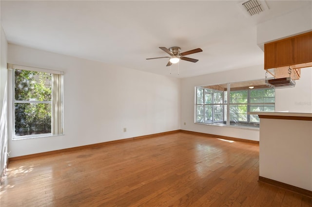 unfurnished living room featuring ceiling fan and wood-type flooring