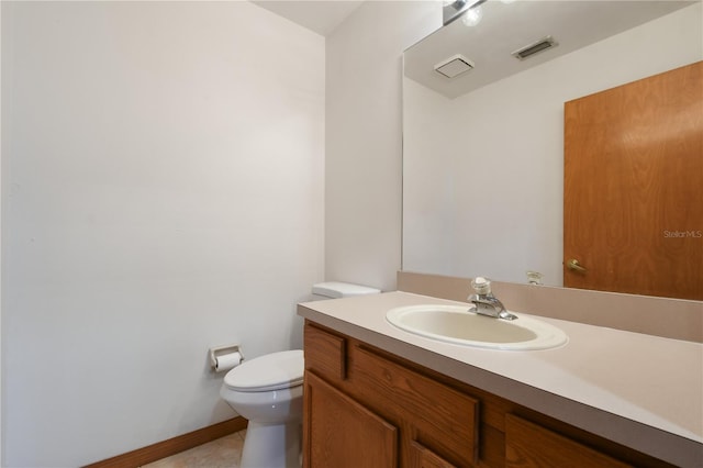 bathroom featuring vanity, toilet, and tile patterned flooring