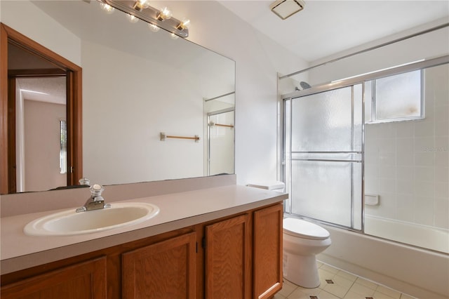 full bathroom with vanity, toilet, and combined bath / shower with glass door