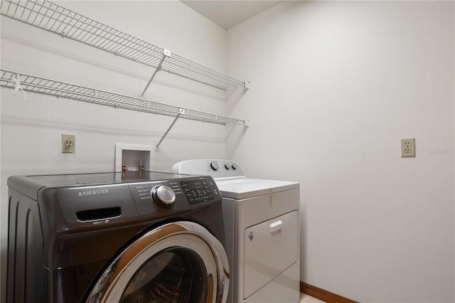 clothes washing area featuring washer and clothes dryer