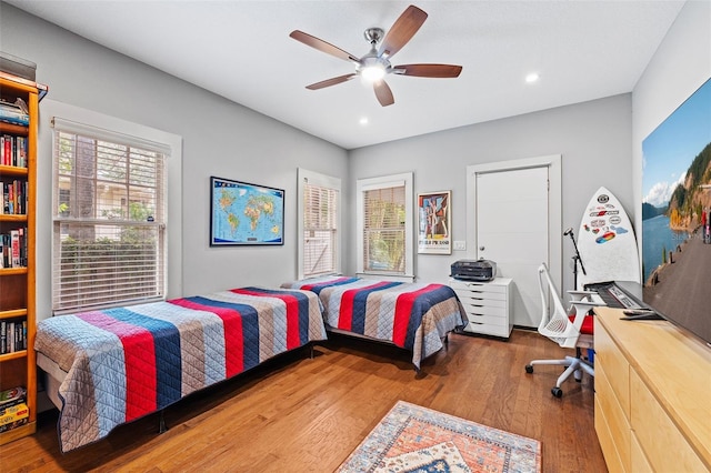 bedroom with wood-type flooring and ceiling fan