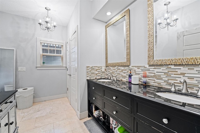 bathroom with vanity, decorative backsplash, and a chandelier