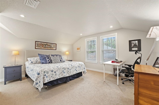 bedroom featuring lofted ceiling, light colored carpet, and a textured ceiling