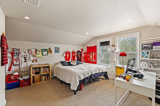 bedroom featuring carpet floors, vaulted ceiling, and a textured ceiling