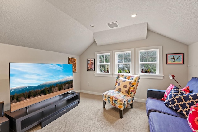 living room featuring vaulted ceiling, carpet floors, and a textured ceiling