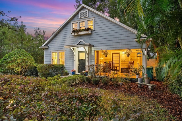 view of back house at dusk