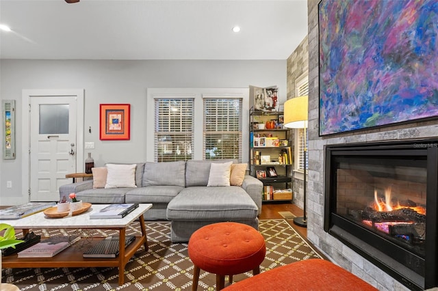 living room with dark hardwood / wood-style floors and a fireplace