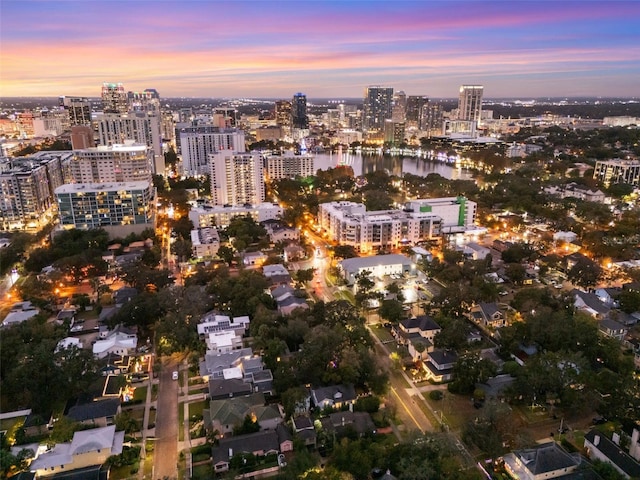 aerial view at dusk featuring a water view