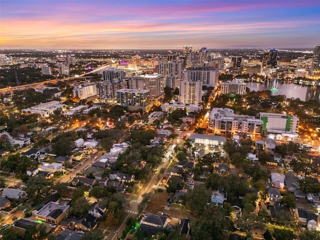 aerial view at dusk featuring a water view