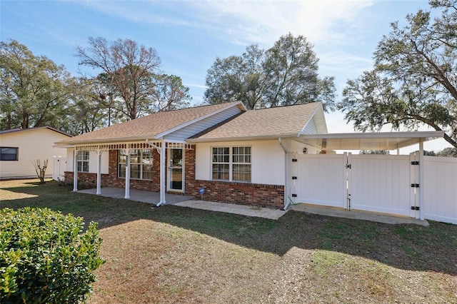 view of front of home with a front yard and a patio area