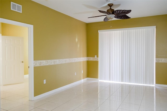 empty room featuring light tile patterned floors and ceiling fan