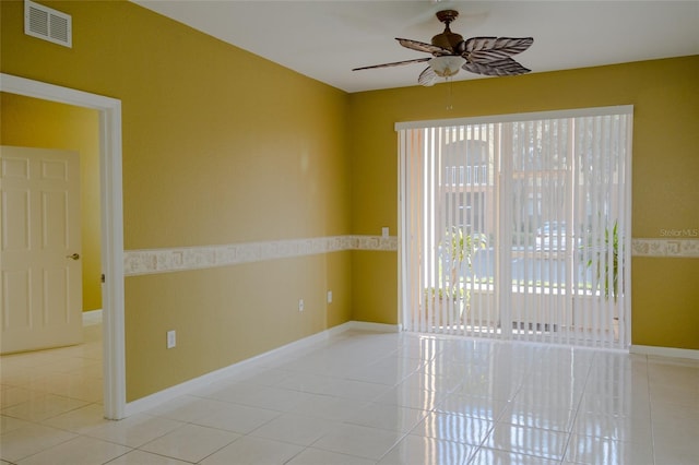 spare room featuring light tile patterned flooring, ceiling fan, and a healthy amount of sunlight