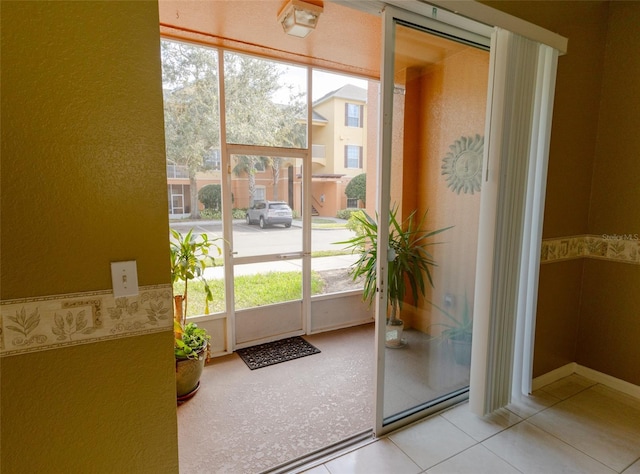 entryway with light tile patterned floors