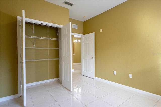 unfurnished bedroom featuring light tile patterned floors and a closet