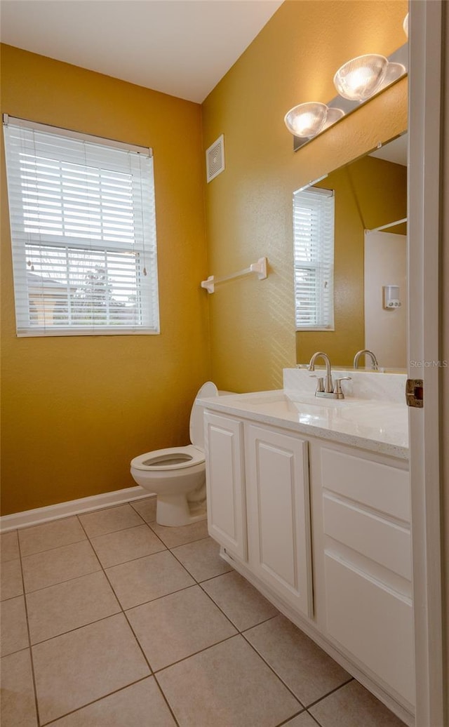 bathroom featuring tile patterned floors, toilet, and vanity