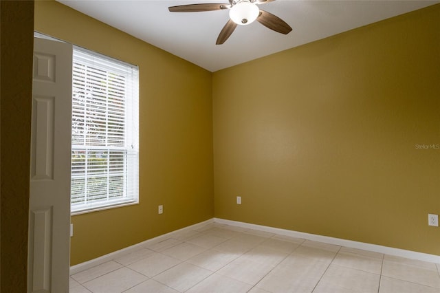 tiled spare room with ceiling fan