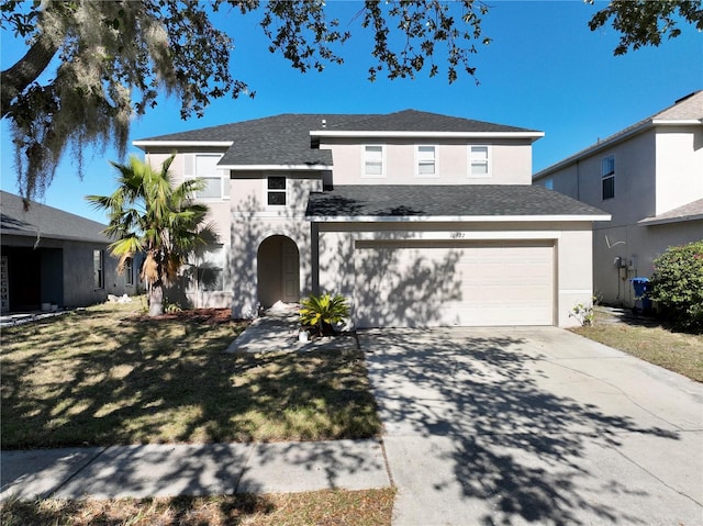 front facade with a garage and a front yard