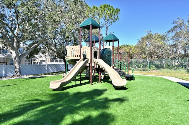 view of jungle gym with a lawn