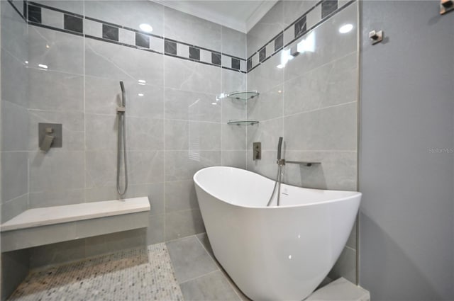 bathroom with ornamental molding, independent shower and bath, and tile walls