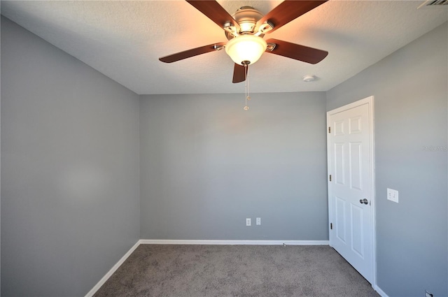 carpeted empty room with ceiling fan and a textured ceiling