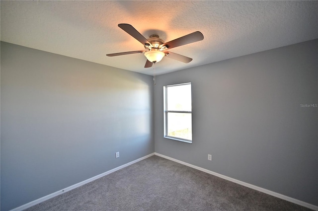 unfurnished room featuring ceiling fan, carpet, and a textured ceiling