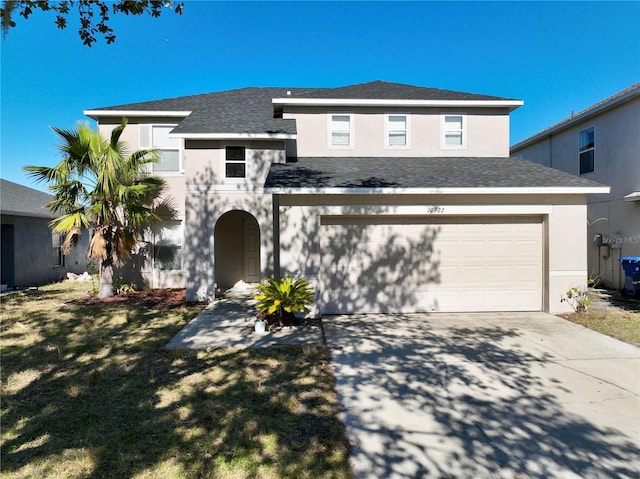 view of front of property with a garage and a front yard