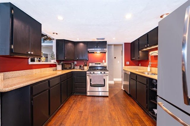 kitchen with dark hardwood / wood-style flooring, sink, and appliances with stainless steel finishes