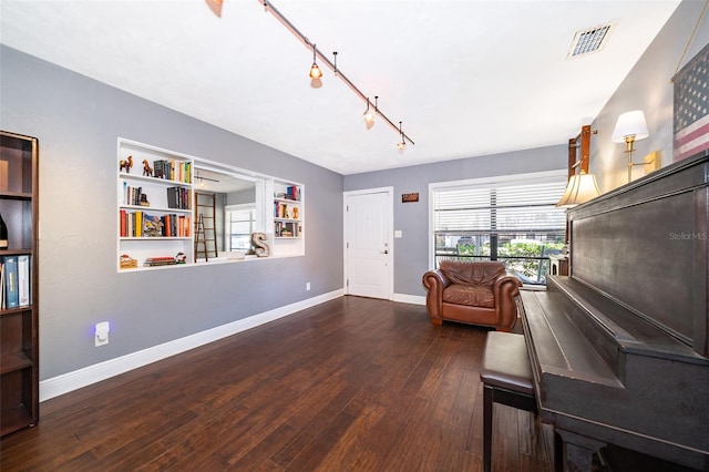 sitting room with track lighting and dark hardwood / wood-style floors