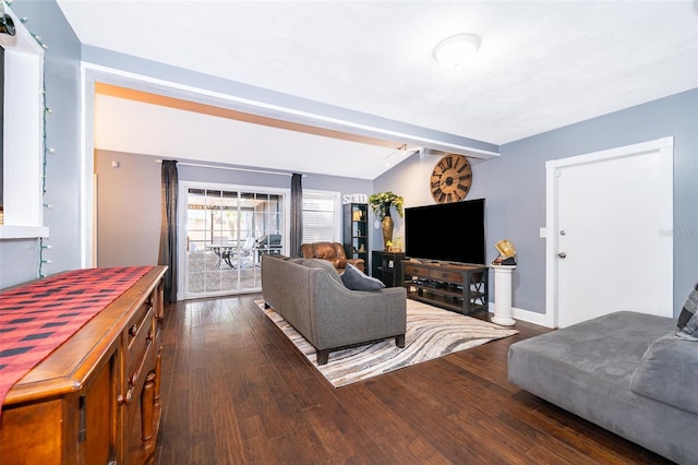 living room with beam ceiling and dark hardwood / wood-style flooring