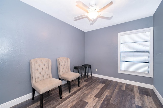 sitting room with dark hardwood / wood-style flooring, plenty of natural light, and ceiling fan