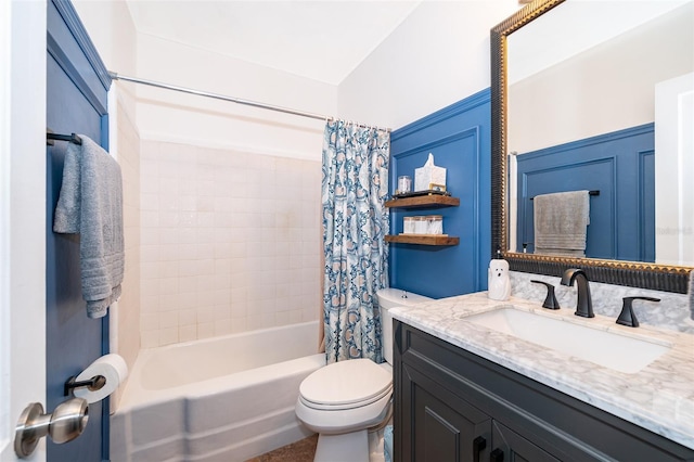 full bathroom with shower / tub combo with curtain, vanity, and toilet