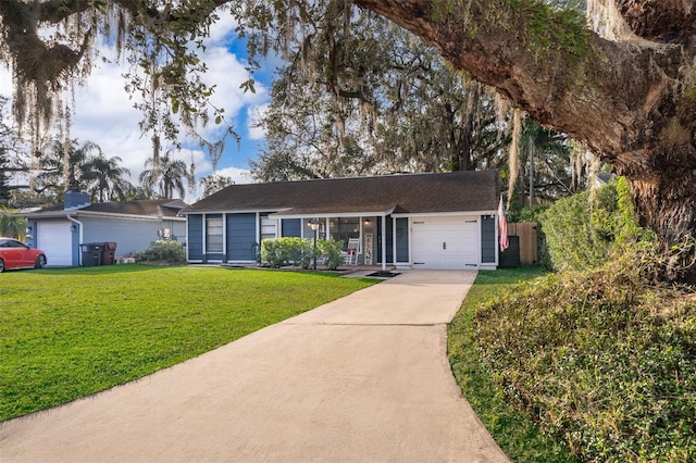 ranch-style house featuring a garage and a front yard