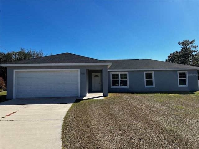 ranch-style house with a garage and a front yard