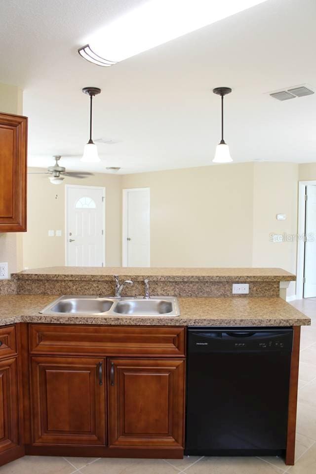 kitchen with pendant lighting, dishwasher, sink, light tile patterned floors, and ceiling fan