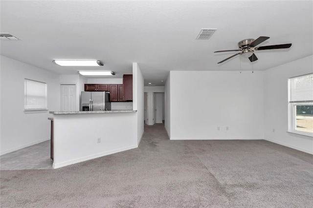 unfurnished living room with light carpet and ceiling fan