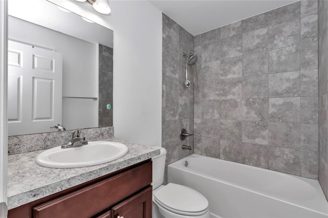 full bathroom featuring vanity, toilet, and tiled shower / bath