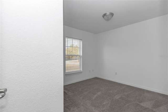 empty room with dark carpet