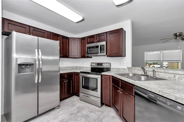 kitchen with ceiling fan, appliances with stainless steel finishes, sink, and light tile patterned floors