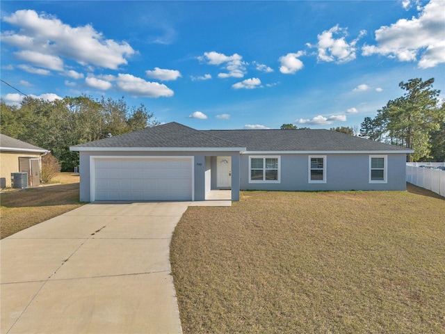 ranch-style home featuring a garage, a front lawn, and central air condition unit