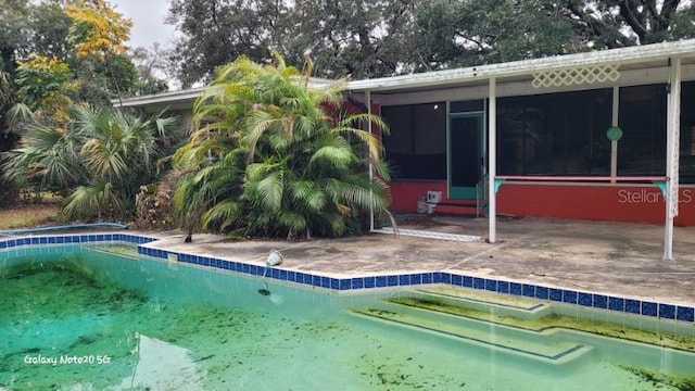 view of pool featuring a sunroom