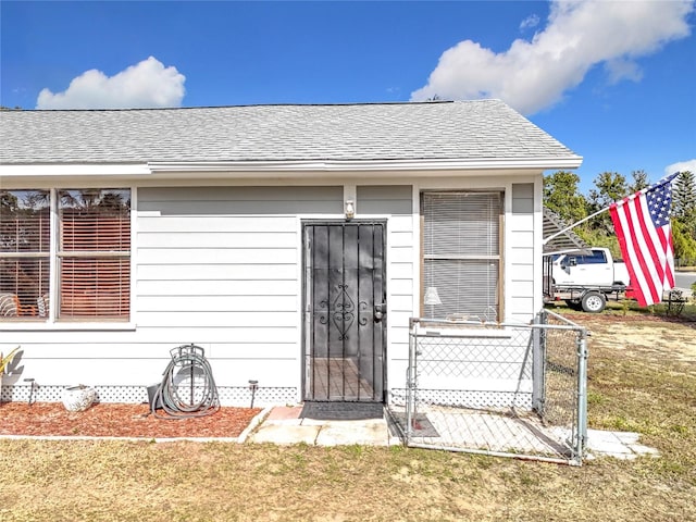 doorway to property with a yard