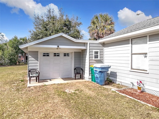 garage featuring a lawn